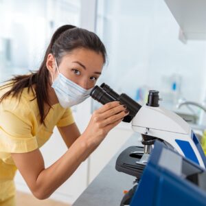 Female vet assistant examining biomaterial in laboratory